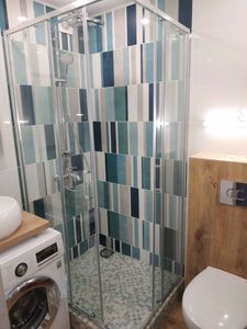 Установлена стеклянная конструкция с низким основанием, подключены водопроводные элементы, закреплены дверцы, герметично обработаны швы, проверена функциональность системы.