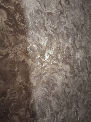 На стене аккуратно размещены фотообои с мраморным узором, создающим эффект глубины и текстуры. Швы тщательно выровнены, поверхность гладкая, без пузырей и складок.