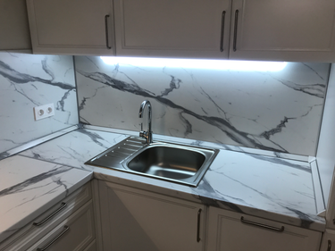 Установлены шкафы, закреплены фасады, смонтирована столешница, подключена мойка, установлена фурнитура, выполнена подгонка элементов, подключены розетки, обеспечено освещение.