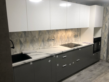 Установлены шкафы, закреплены фасады, смонтирована столешница, подключены мойка и варочная панель, встроена духовка, выполнена отделка фартука, установлены розетки.