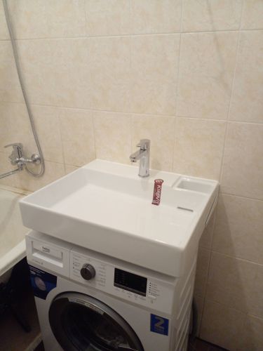 Установлена новая раковина над стиральной машиной, подключен смеситель и слив, проверена герметичность соединений, обеспечена функциональность и эстетичность в ванной комнате.