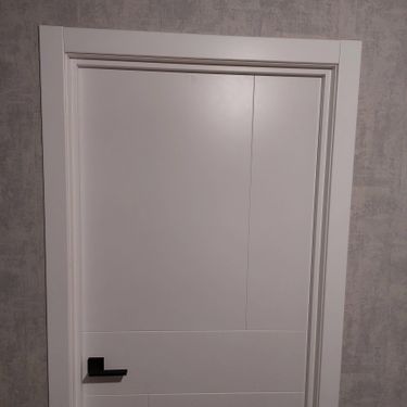 На полотне двери выполнено аккуратное углубление для замка, установлена фурнитура, ручка закреплена, механизм функционирует исправно, обеспечивая надежное закрытие.