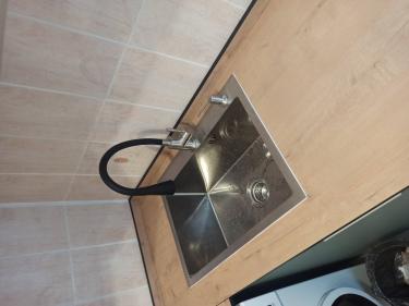 Установлено устройство для измельчения отходов под раковиной, подключено к водопроводу и электросети, проверена работоспособность, обеспечена герметичность соединений, выполнена чистовая отделка.