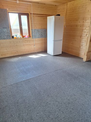 На полу ровно уложено покрытие, без видимых стыков и волн. Основание подготовлено, поверхность гладкая и аккуратная, создавая уютную атмосферу в помещении.