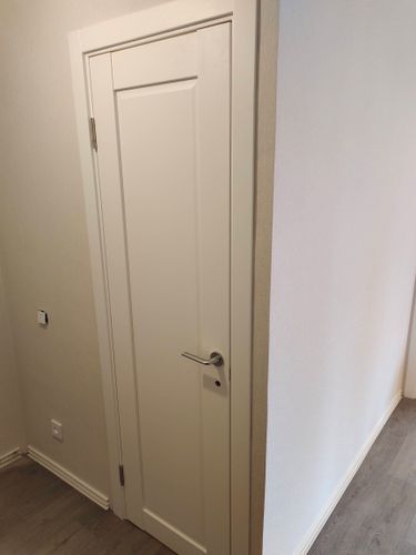 Установлена новая деревянная створка, закреплены петли, врезан замок, отрегулирована фурнитура, выполнена отделка проема, проверена плавность открывания.