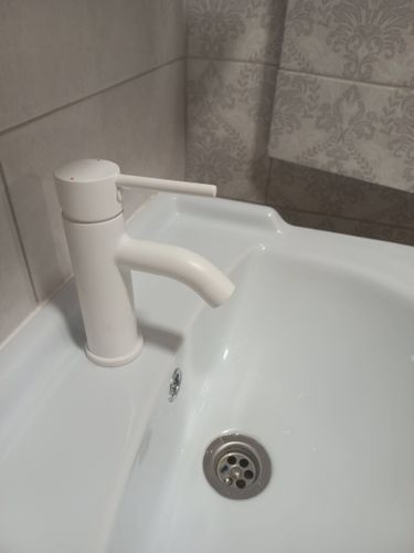 Установлен новый белый кран на раковину, обеспечивающий надежное соединение и герметичность. Обновлен внешний вид ванной комнаты, улучшена функциональность водопровода.