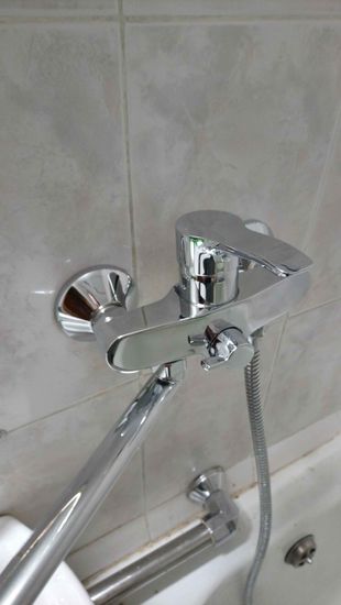 Изображение демонстрирует завершение снятия смесителя с раковины. Удалены крепления, отсоединены трубы, обеспечена чистота поверхности для дальнейших работ.