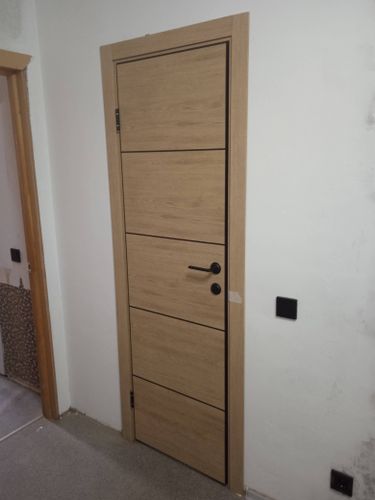 Установлена деревянная створка, закреплены петли, врезан замок, прикреплена ручка, отрегулированы зазоры, выполнена отделка проема, обеспечена плавная работа конструкции.