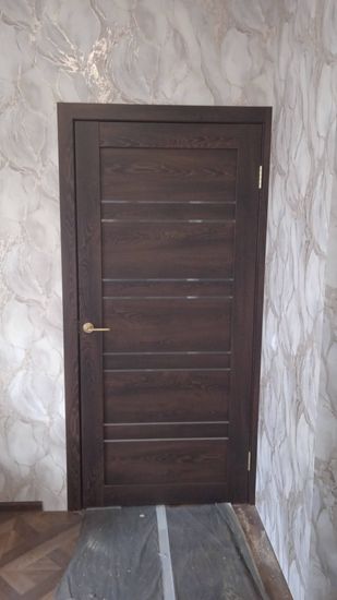 Выполнена установка запорного механизма в дверь. Проведены работы по подготовке отверстия, закреплению ручки и проверке функционирования. Обеспечена точность и аккуратность монтажа.