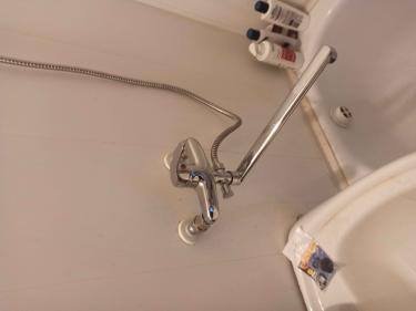 Новое устройство закреплено на стене, подключены водопроводные трубы, проверена герметичность соединений, установлен гибкий шланг и излив, обеспечена функциональность.