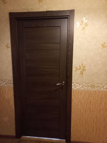 Установлена новая дверная конструкция: закреплена коробка, навешено полотно, врезана ручка, отрегулированы петли, оформлены наличники, обеспечена плавная работа, завершены отделочные штрихи.