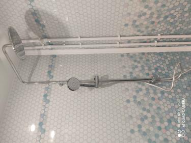 Установлена угловая ванна, подключены смеситель и душ, выполнена герметизация швов, проверена система слива, закреплены трубы, произведена облицовка стен плиткой с узором.