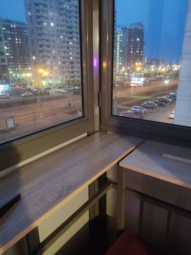 Установлена деревянная полка на балконе, закреплена на металлических уголках, обеспечивающих устойчивость. Конструкция надежно зафиксирована, готова к использованию.