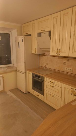 Установлены шкафы, смонтирована столешница, встроена техника, закреплены фасады, подключены розетки, размещена вытяжка, установлена варочная поверхность, завершена отделка стен.