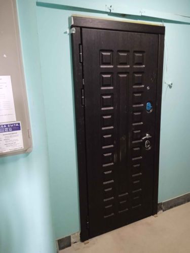 Установлена новая металлическая дверь, закреплена в проеме, проверена функциональность замков и петель, обеспечена надежная изоляция, выполнена отделка откосов, устранены зазоры.