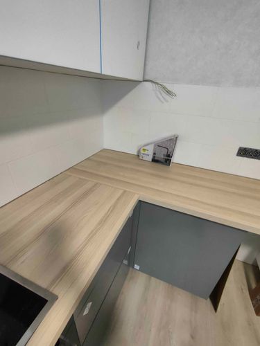 Выполнена установка столешницы: аккуратный распил, точная подгонка углов, гладкие стыки. Поверхность ровная, без зазоров, идеально вписывается в кухонное пространство.