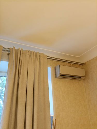 Установлен кондиционер, закреплен карниз для штор, повешены занавески, проведена покраска потолка, обновлены обои на стенах, улучшена изоляция окна.