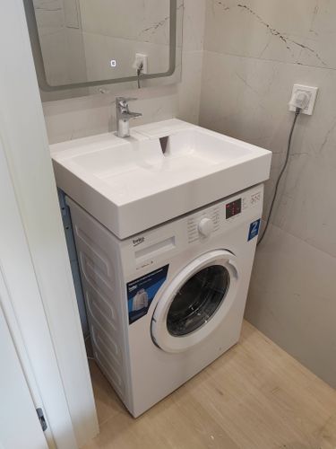 Установлена новая раковина на стиральную машину, подключены коммуникации, проверена герметичность соединений, отрегулированы краны, завершена отделка стен вокруг, убран мусор.