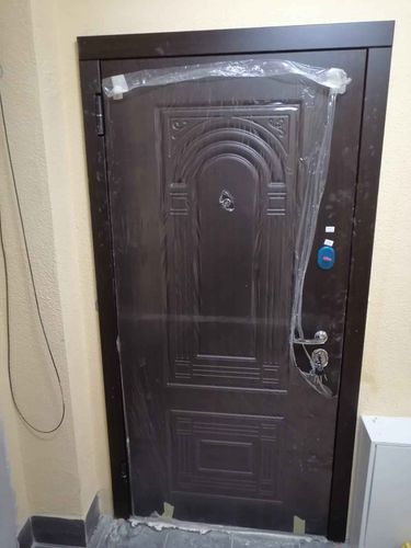 Установлены МДФ панели на входную конструкцию, обеспечивая эстетичный вид и дополнительную изоляцию. Завершено оформление поверхности, включая монтаж декоративных элементов и защитной пленки.