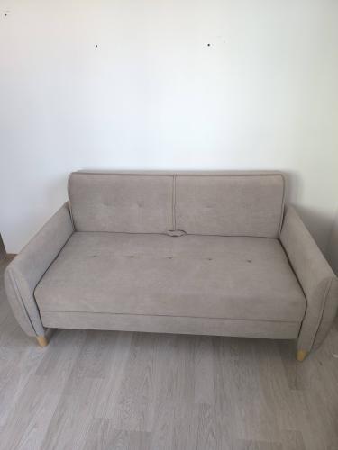 Собран диван: установлены ножки, прикреплены подлокотники, соединены спинка и сиденье, проверена устойчивость конструкции, обеспечена надежность креплений, завершена установка.