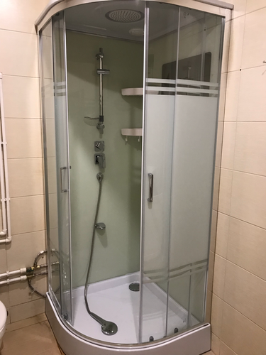 Установлена современная душевая кабина с прозрачными дверцами, оборудована полками, подключены водопровод и слив, выполнена отделка стен, обеспечена герметичность соединений.