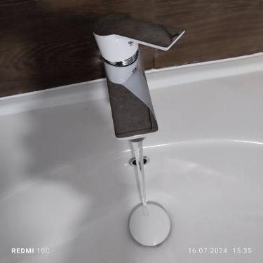 Изображение демонстрирует завершенную установку нового бачка на унитаз, включая подключение к водопроводу и проверку герметичности всех соединений. Работа выполнена аккуратно и качественно.