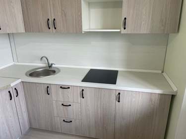 Установлены шкафы, закреплены фасады, смонтирована столешница, врезана мойка, подключена варочная панель, установлены ручки. Завершена сборка и монтаж кухонного гарнитура.