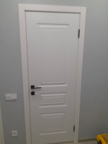 Установлена новая деревянная створка, закреплены петли, врезана ручка, отрегулированы зазоры, завершена отделка проема наличниками.