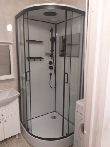 Установлена новая душевая кабина, демонтирована старая ванна, проведены работы по подключению водоснабжения и канализации, выполнена отделка стен, установлены стеклянные двери.