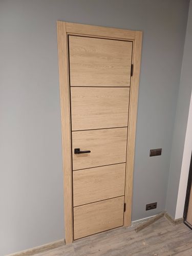 Установлена новая деревянная створка, закреплена в проеме, навешены петли, врезана ручка, отрегулирована фурнитура, обеспечена плавность открывания, завершена отделка наличниками.