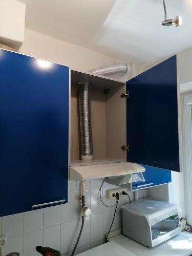 Установлена система воздуховодов: гибкий канал подключен к вытяжке и выведен через шкаф, обеспечивая эффективную вентиляцию. Все элементы надежно закреплены и герметично соединены.