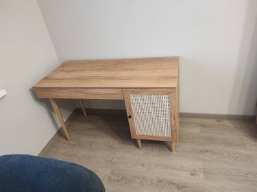 Собран деревянный комод: установлены ножки, прикреплены дверцы, закреплены ручки. Все элементы соединены, конструкция устойчива, поверхность ровная, готова к использованию.