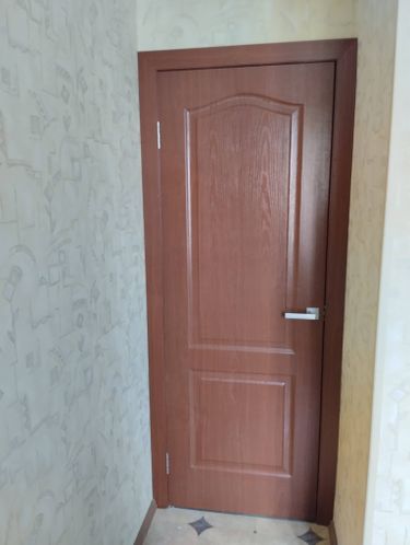 Установлена новая межкомнатная дверь с деревянной отделкой. Проведены работы по монтажу коробки, навешиванию полотна, закреплению петель и ручки. Проверена плавность открывания.