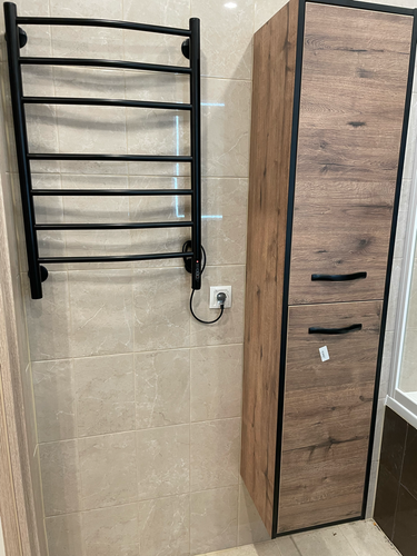 Закреплен прибор на стене, подключен к сети через розетку, проверена работоспособность. Устройство установлено в ванной комнате, обеспечивая комфортное использование.