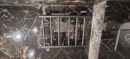 На стене ванной комнаты закреплён электрический полотенцесушитель. Устройство подключено к электросети, проводка скрыта. Установлена надёжная фиксация, обеспечена безопасность эксплуатации.