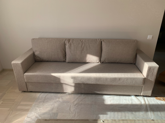 Собран диван: установлены каркас, подлокотники, спинка, сиденье и подушки. Все элементы соединены, проверена устойчивость, обеспечена надежность конструкции.