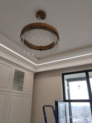 Закреплена люстра на натяжной поверхности, подключены провода, проверена работа освещения, установлены декоративные элементы. Завершено оформление потолка в интерьере.